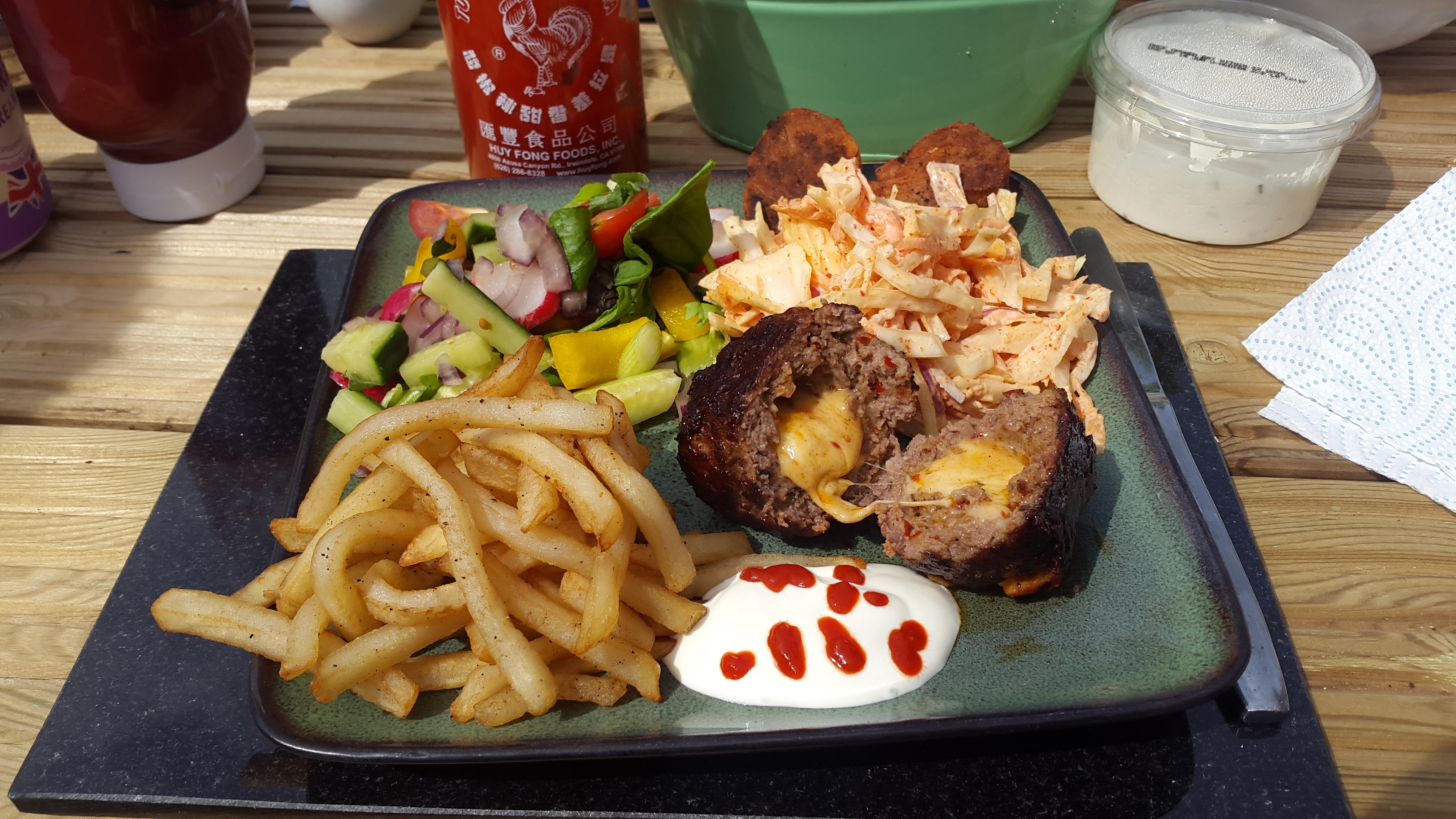 Cheese-stuffed Mexican meatballs served with coleslaw, salad and fries