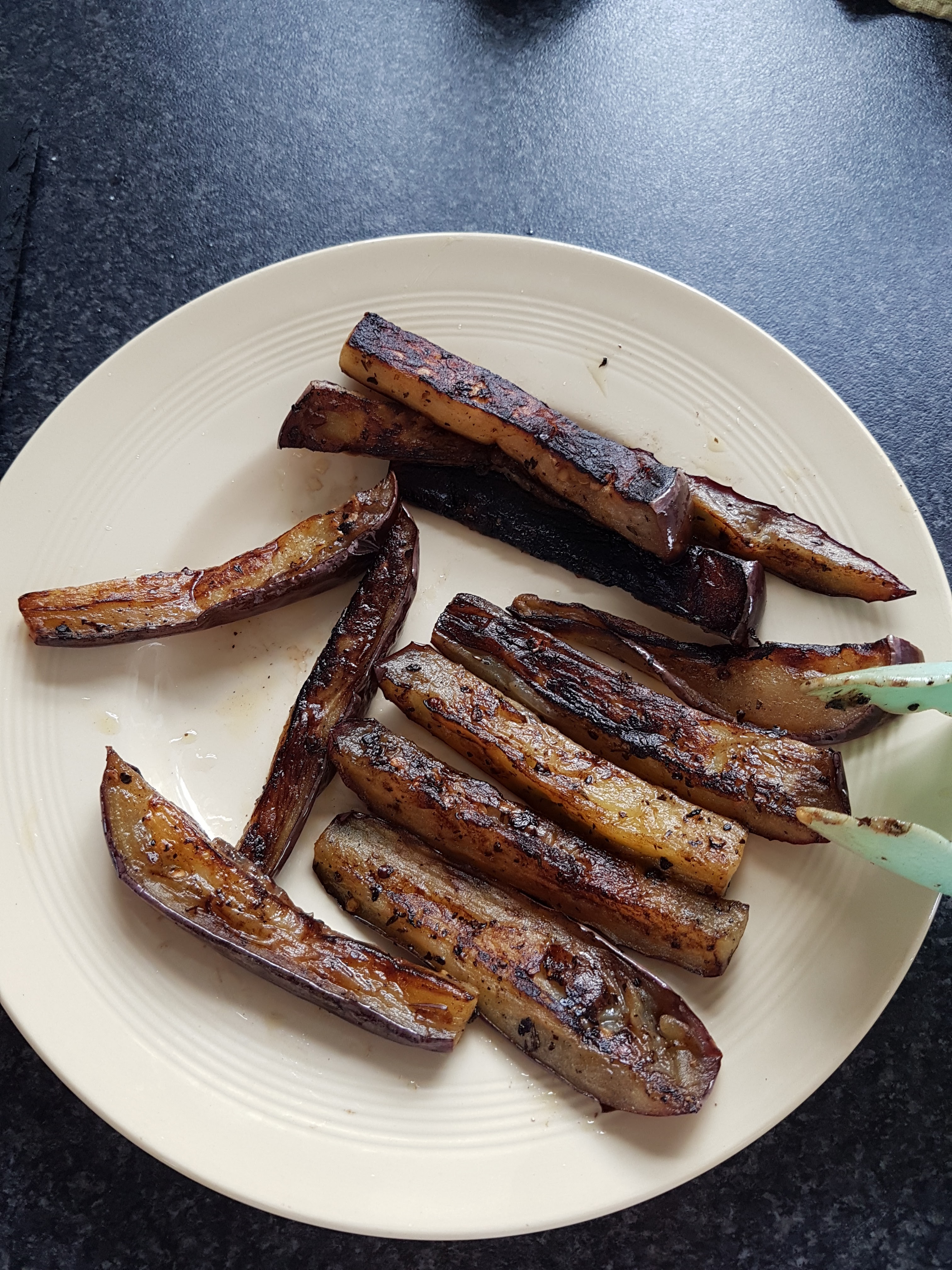 Aubergine strips cooking until golden for the warm potato salad
