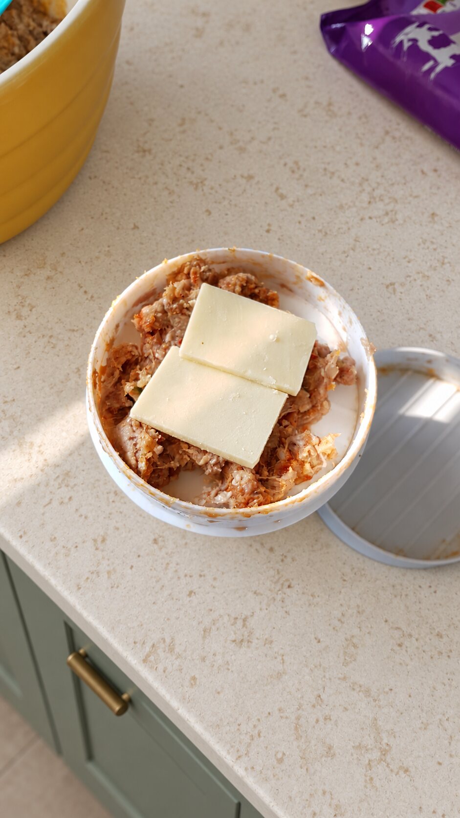 Thin cheese slices placed in the centre of homemade burger mixture